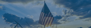 American flag waving in the cloudy sky